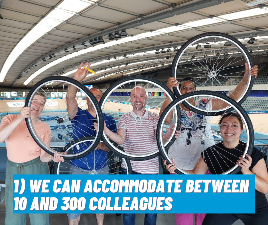 Five Bloomberg employees holding up a cycle tyre during a Bikeworks team building event at the Lee Valley Velodrome