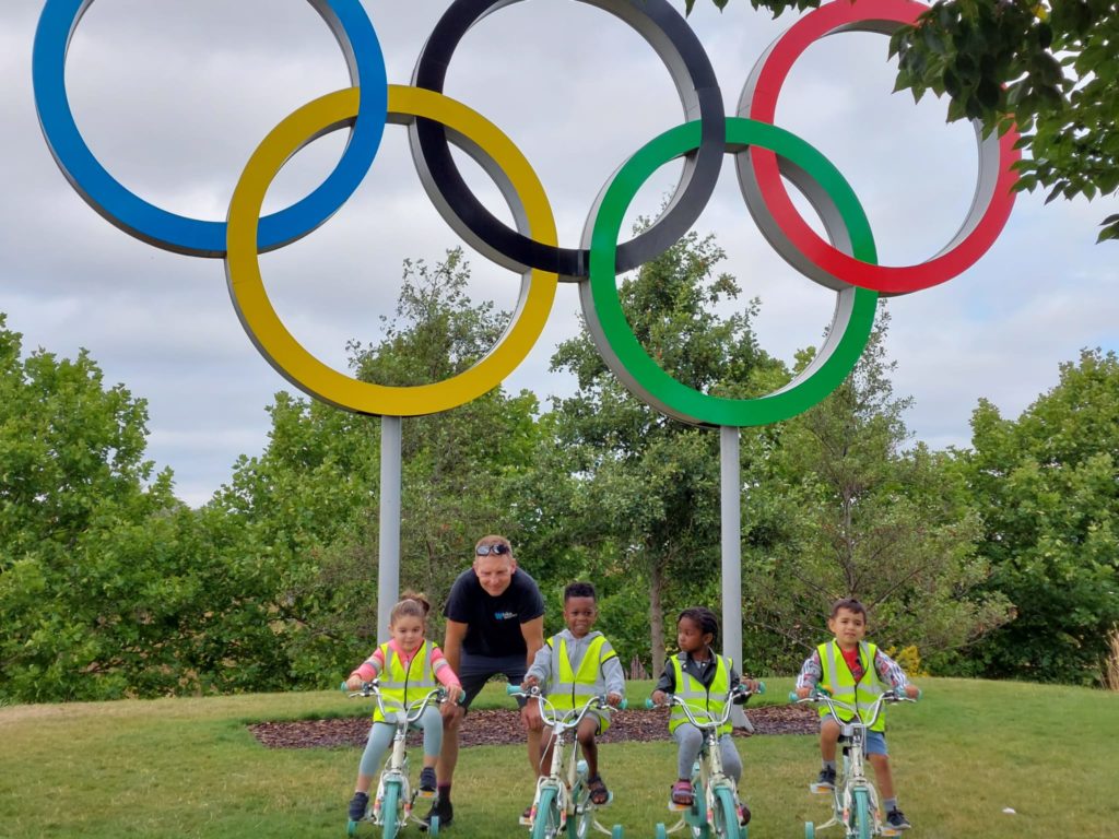 Co-CEO Jim Blakemore with LEYF nursery school children on donated cycles on the Olympic Park.