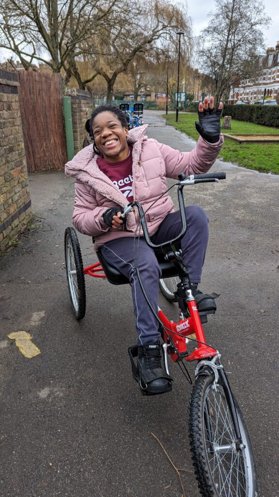 A rider of the All Ability Club cycling on a trike
